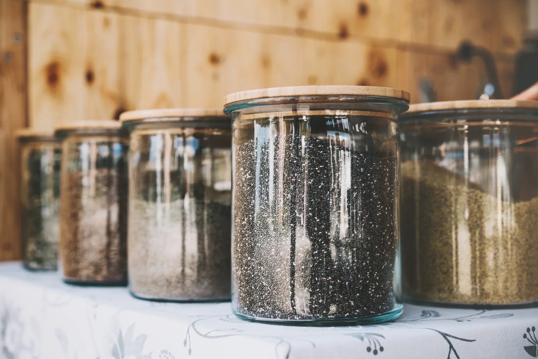 Airtight glass jars storing loose tea and spices to keep chai fresh and flavorful for longer.