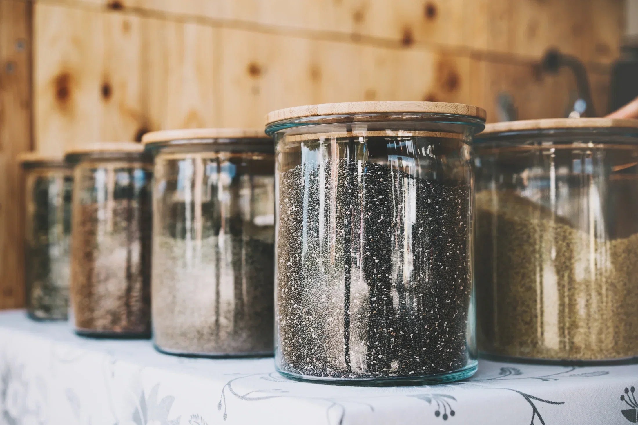 Airtight glass jars storing loose tea and spices to keep chai fresh and flavorful for longer.
