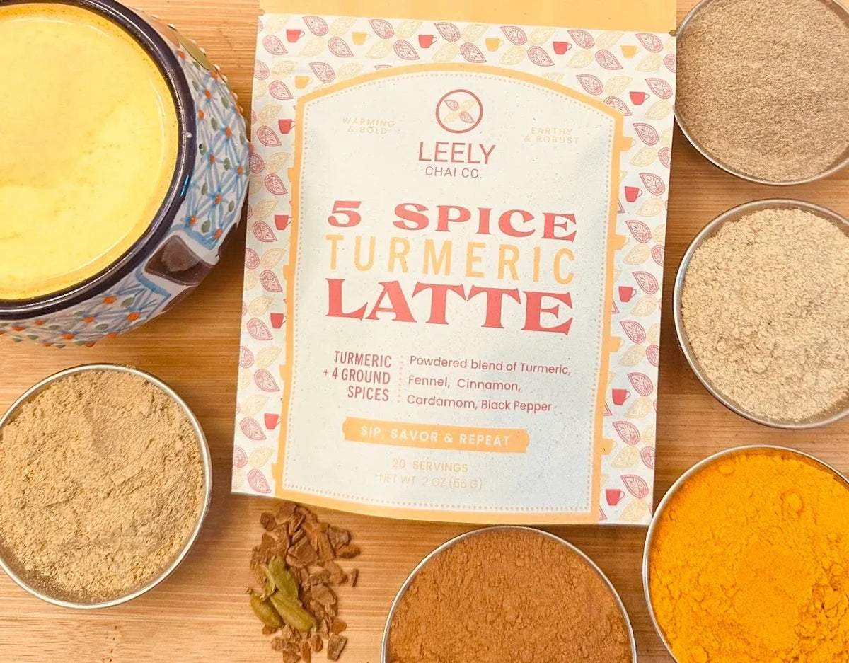 Leely Chai Co. 5 Spice Turmeric Latte beside a prepared cup and bowls of ground spices.